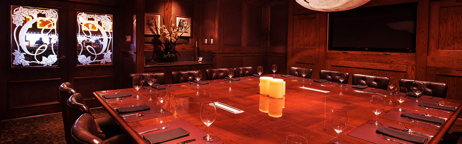 Crest Hotel board room with conference table and TV