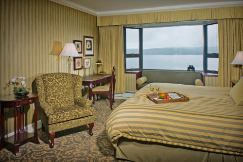 Tray with wine on hotel bed