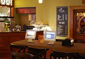 Two computers on a cafe table