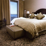 Bed with green throw pillows