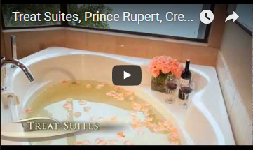  bathtub with rose pedals floating in the water and wine on the ledge