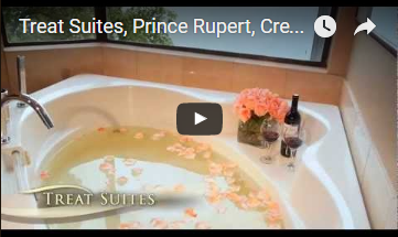 bathtub with rose pedals floating in the water and wine on the ledge