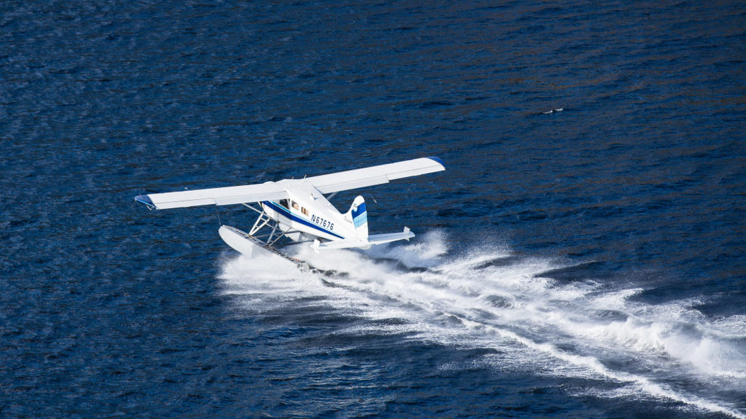 Sea plane racing along the water