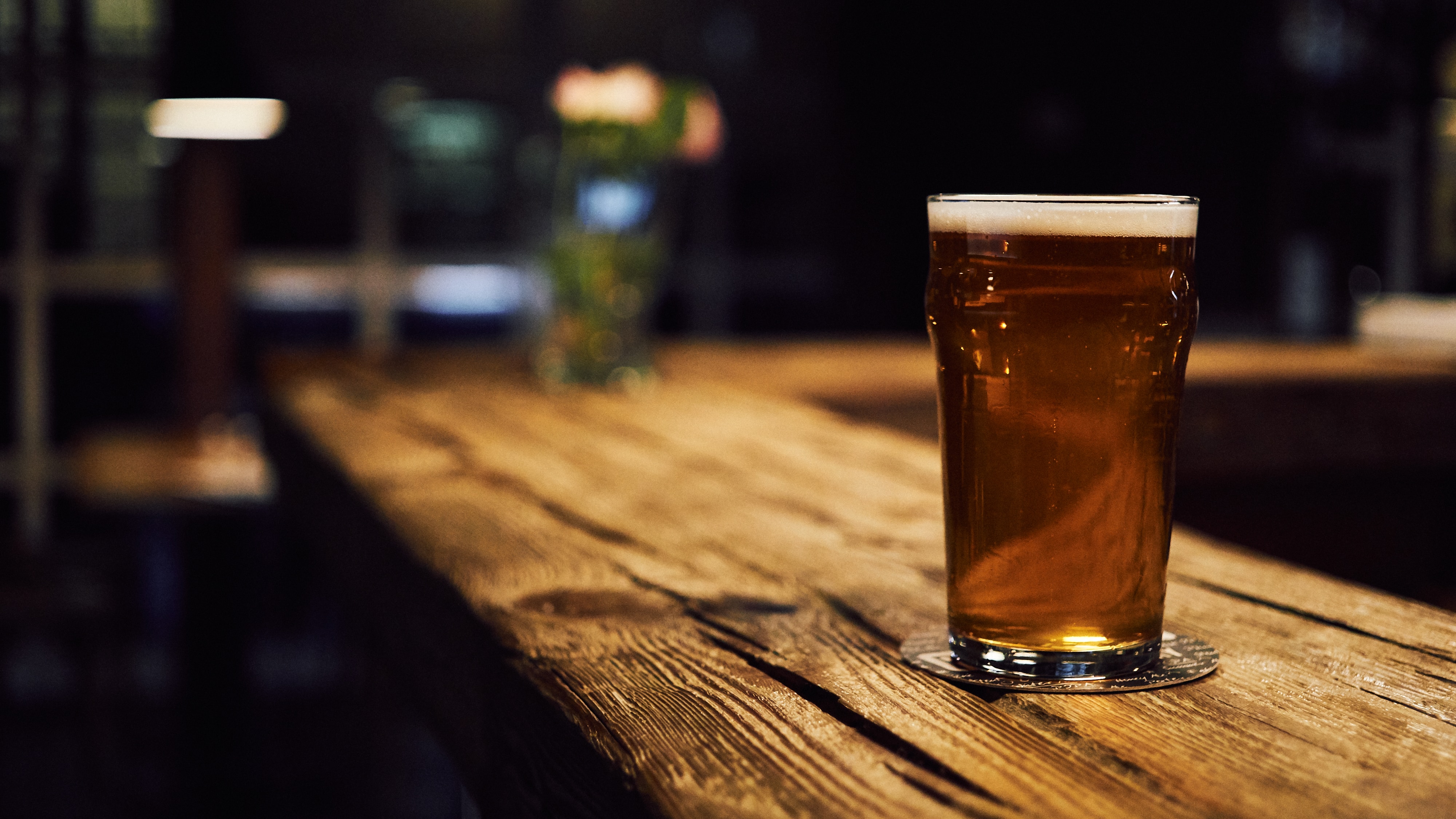 Beer glass on a rustic wooden bar